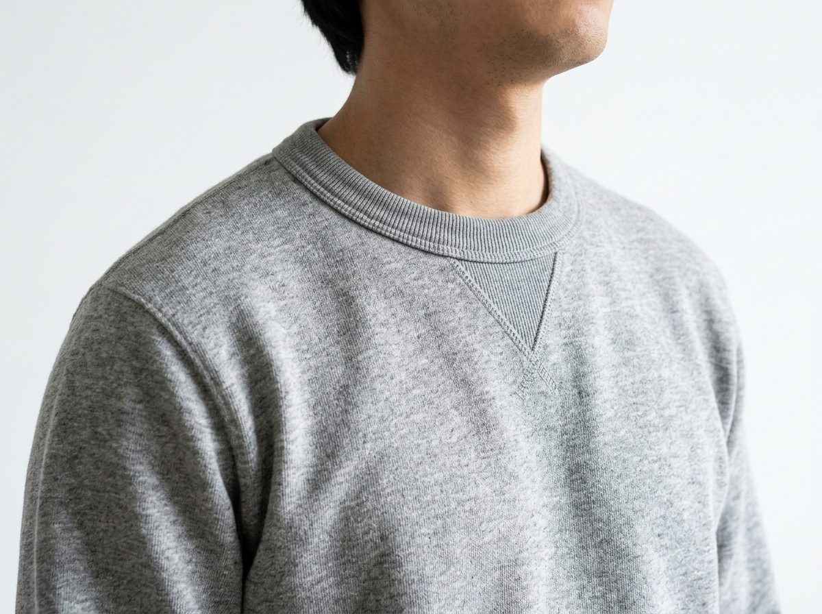 Heather grey crewneck sweatshirt with ribbed collar and triangle V-stitch