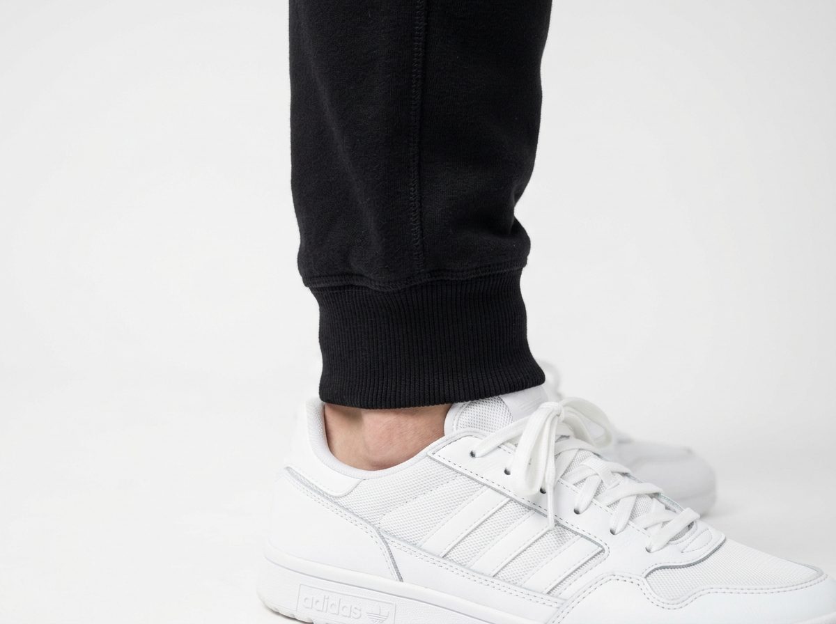 Black cotton fleece joggers with tapered leg and snug 1x1 ribbed ankle cuff