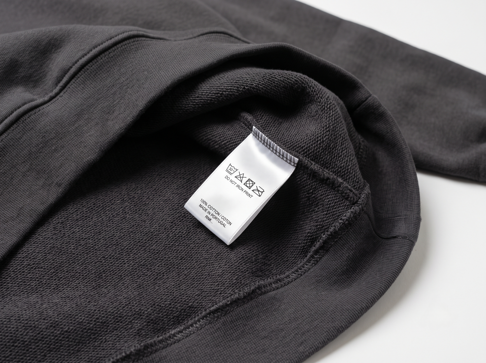 Heavyweight fleece hoodie turned inside out showing clean interior loopback fleece and wash care label