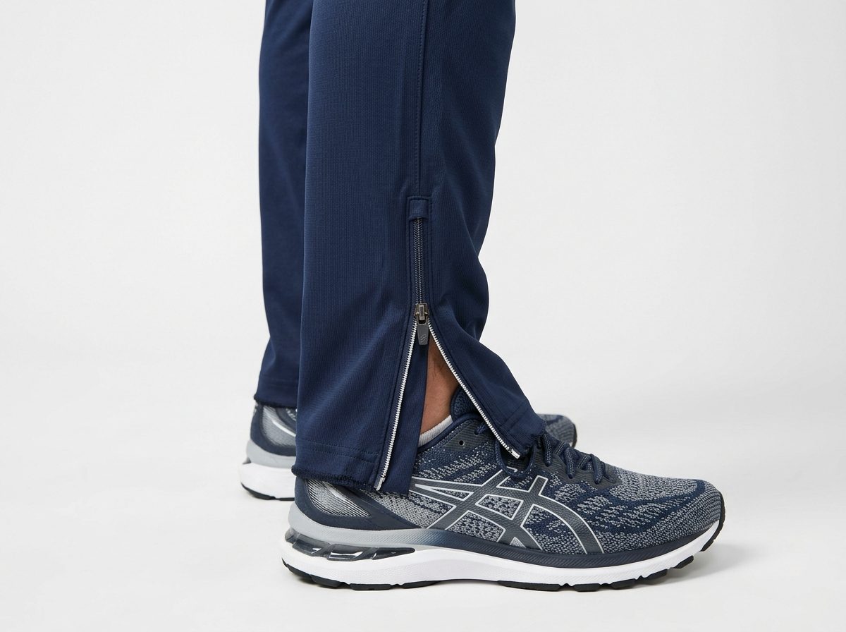 Navy blue athletic trackpants with straight open hem and ankle zipper